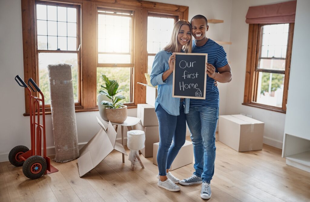 A joyful couple receiving the keys to their new luxury home, representing the success of first time home buyer loans